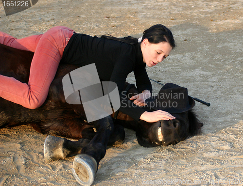 Image of horse laid down and teen
