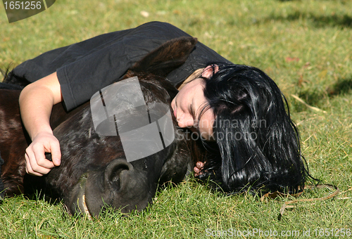 Image of horse laid down and riding girl