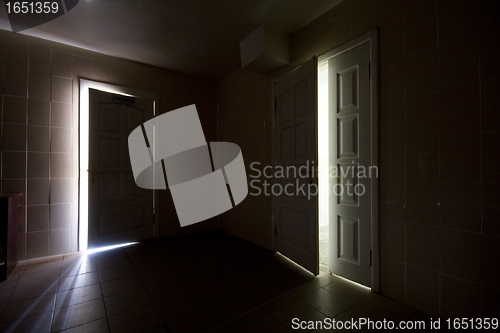 Image of Inside a dark room with half-opened doors