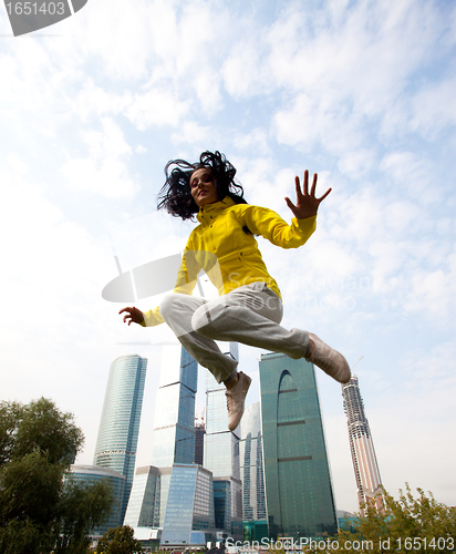 Image of girl in a yellow blazer jumping