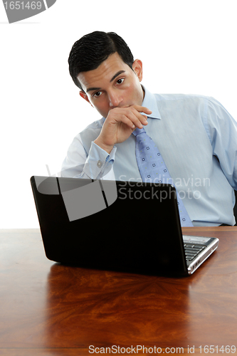 Image of Man sitting at desk thinking pondering