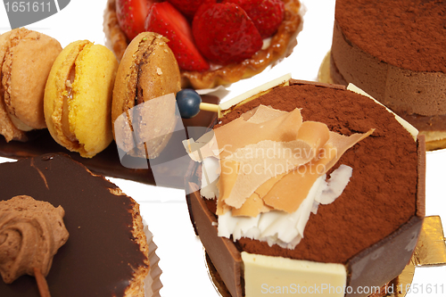 Image of assortment of small cakes on a white background