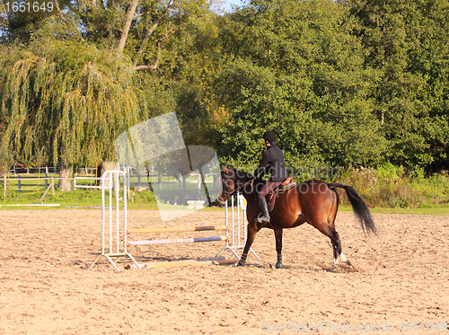 Image of pretty young woman rider in a competition riding