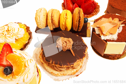 Image of assortment of small cakes on a white background