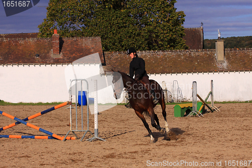 Image of pretty young woman rider in a competition riding