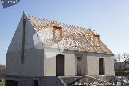 Image of house under construction with the roof structure of wood