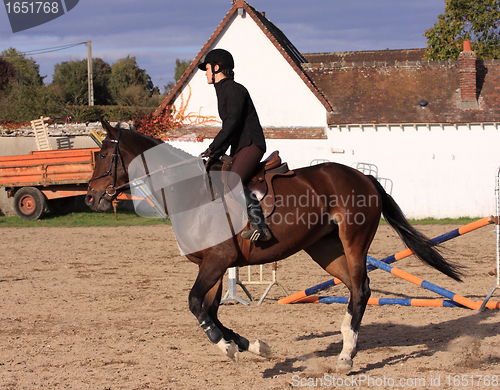 Image of pretty young woman rider in a competition riding