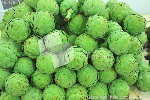 Image of large fresh artichokes on a market stall