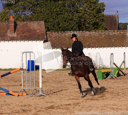 Image of pretty young woman rider in a competition riding