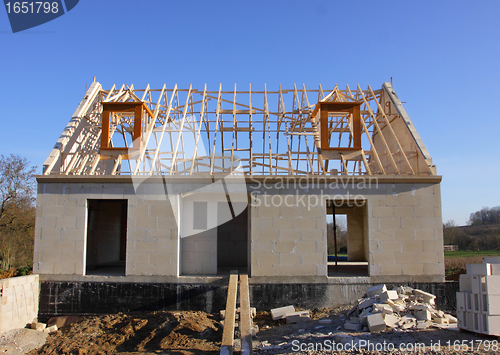 Image of house under construction with the roof structure of wood