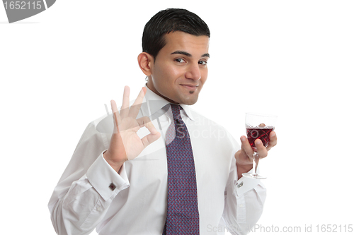 Image of A man with wine shows approval or excellence