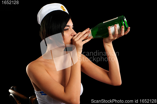 Image of Young beautiful sailor woman with bottle