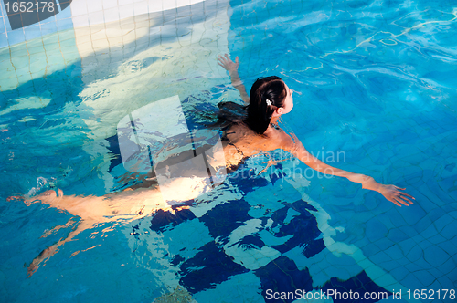 Image of Attractive girl in swimming pool