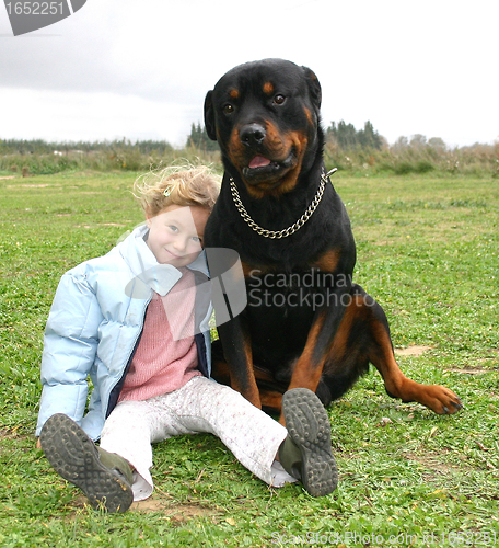 Image of rottweiler and little girl