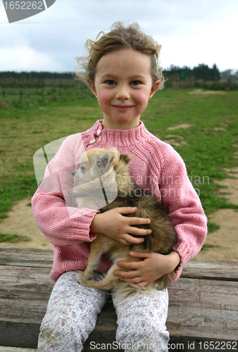 Image of child and chihuahua