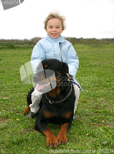 Image of rottweiler and little girl