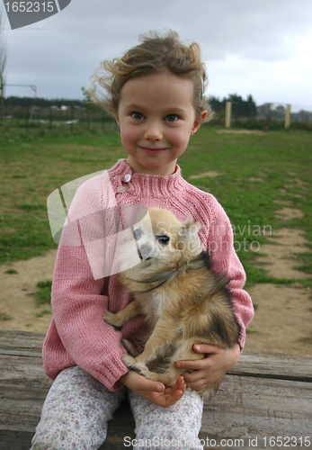 Image of child and chihuahua