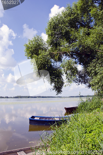 Image of Boats anchored on coast. Willow in spring 