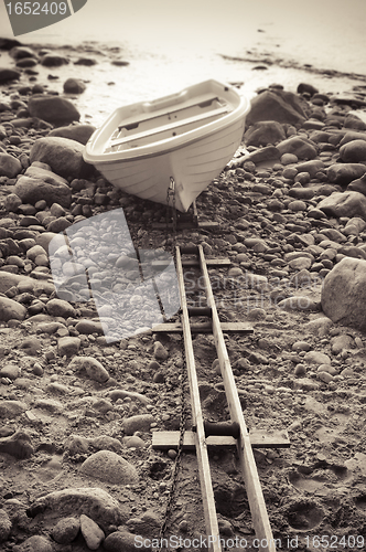 Image of Fishing boat on stony to seacoast