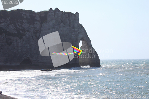Image of kite in a blue sky above the sea
