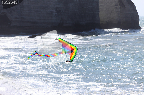 Image of kite in a blue sky above the sea