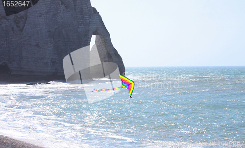 Image of kite in a blue sky above the sea