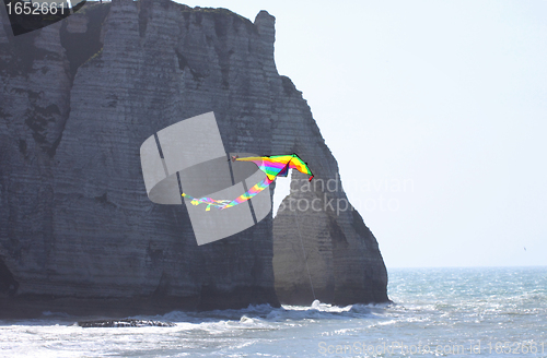 Image of kite in a blue sky above the sea