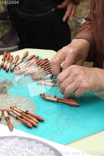 Image of Process of lace-making with bobbins 