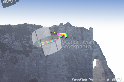 Image of kite in a blue sky above the sea