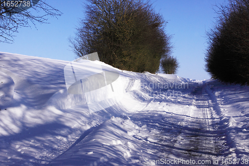 Image of snowy road in the winter sun in France