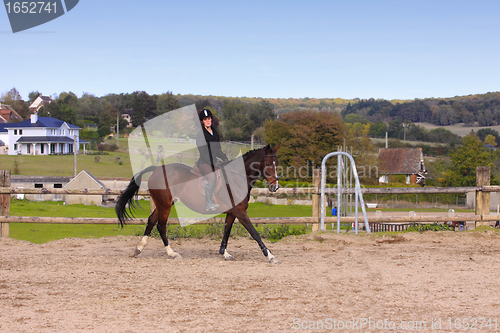 Image of pretty young woman rider in a competition riding