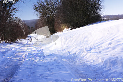 Image of snowy road in the winter sun in France