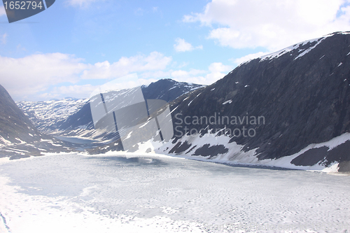 Image of frozen lake and snowy mountains in norway