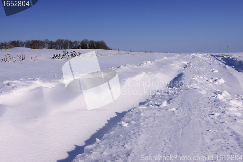 Image of snowy road in the winter sun in France