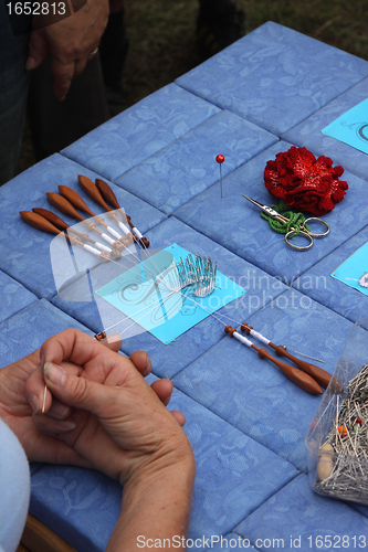 Image of Process of lace-making with bobbins 