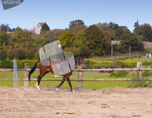 Image of pretty young woman rider in a competition riding