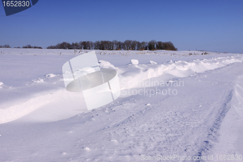 Image of snowy road in the winter sun in France