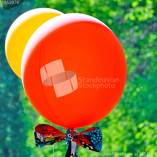 Image of  Red and yellow balloons on green background