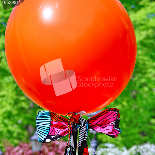 Image of  Red balloon on green background 