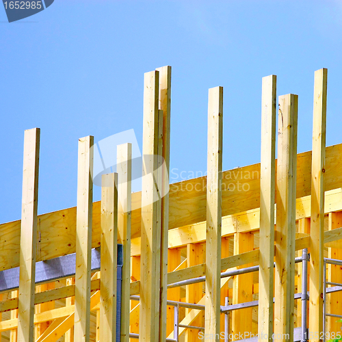 Image of  Wooden house frame against blue sky