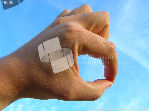 Image of Hand on blue sky