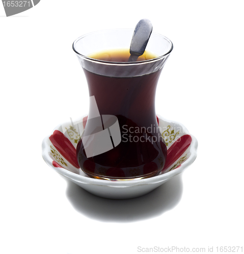 Image of Brewed tea mixed with sugar spoon