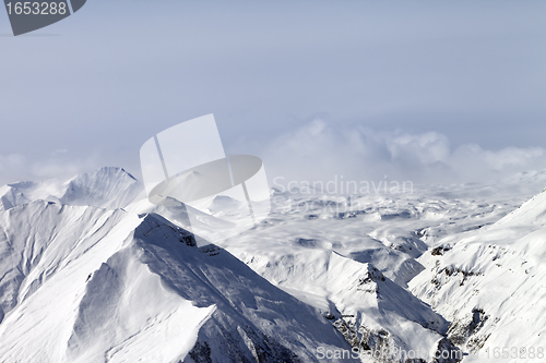 Image of Snowy mountains in clouds