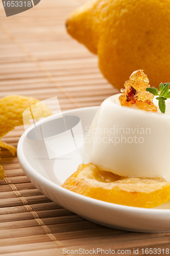 Image of Vanilla Panna Cotta Dessert with lemon and fresh herbs