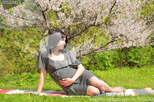 Image of pregnant woman in the spring garden