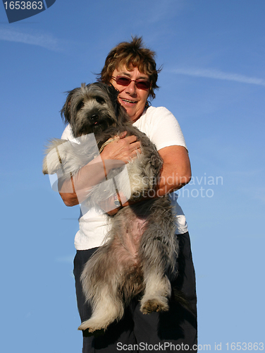 Image of Pyrenean sheepdog and senior woman