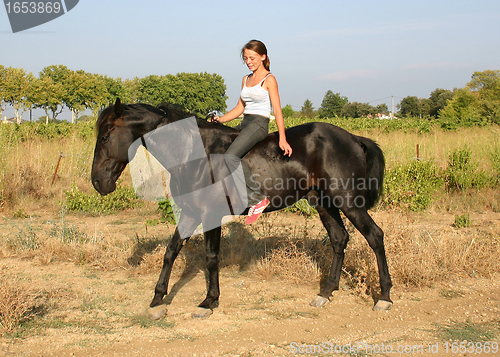 Image of young woman and horse