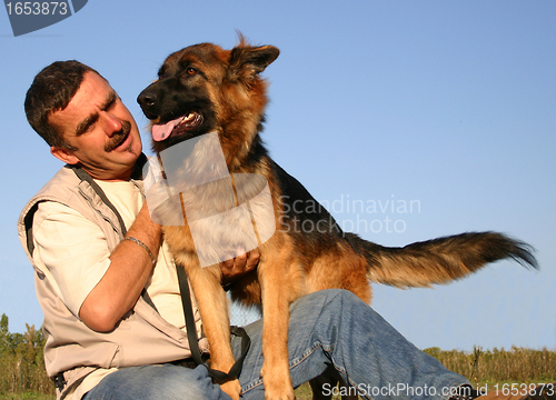 Image of german shepherd and man