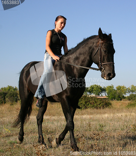 Image of young woman and horse