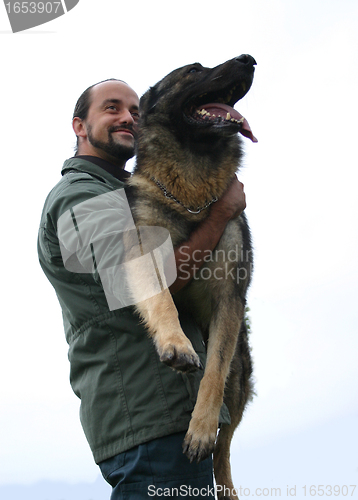 Image of german shepherd and man